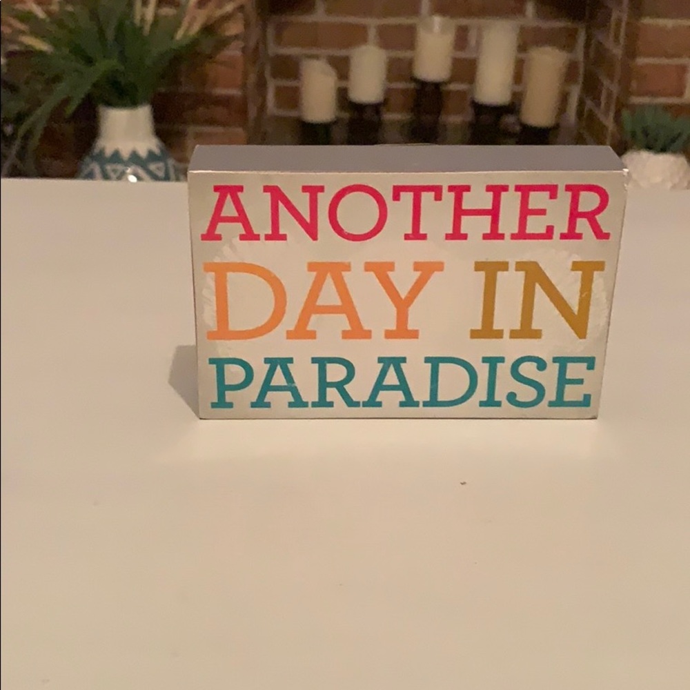 “Another day in paradise” sign